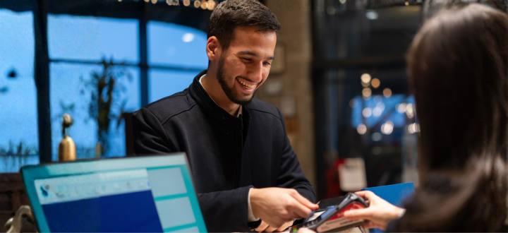 Business man using credit card at htoel front desk