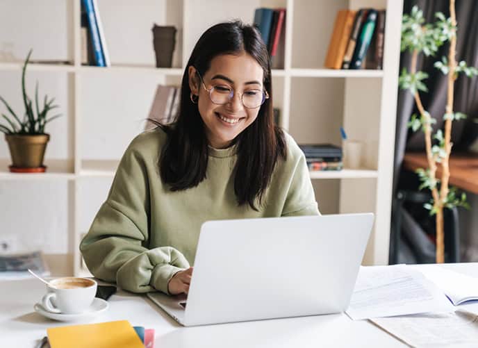 Happy woman looking at her laptop